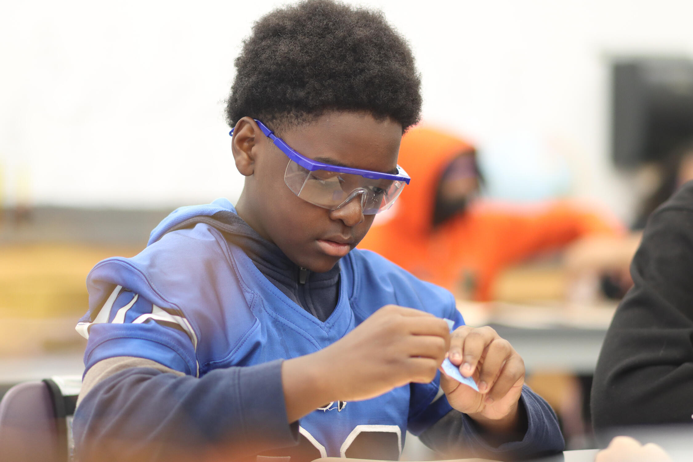 Student wearing safety glasses working on a science experiment