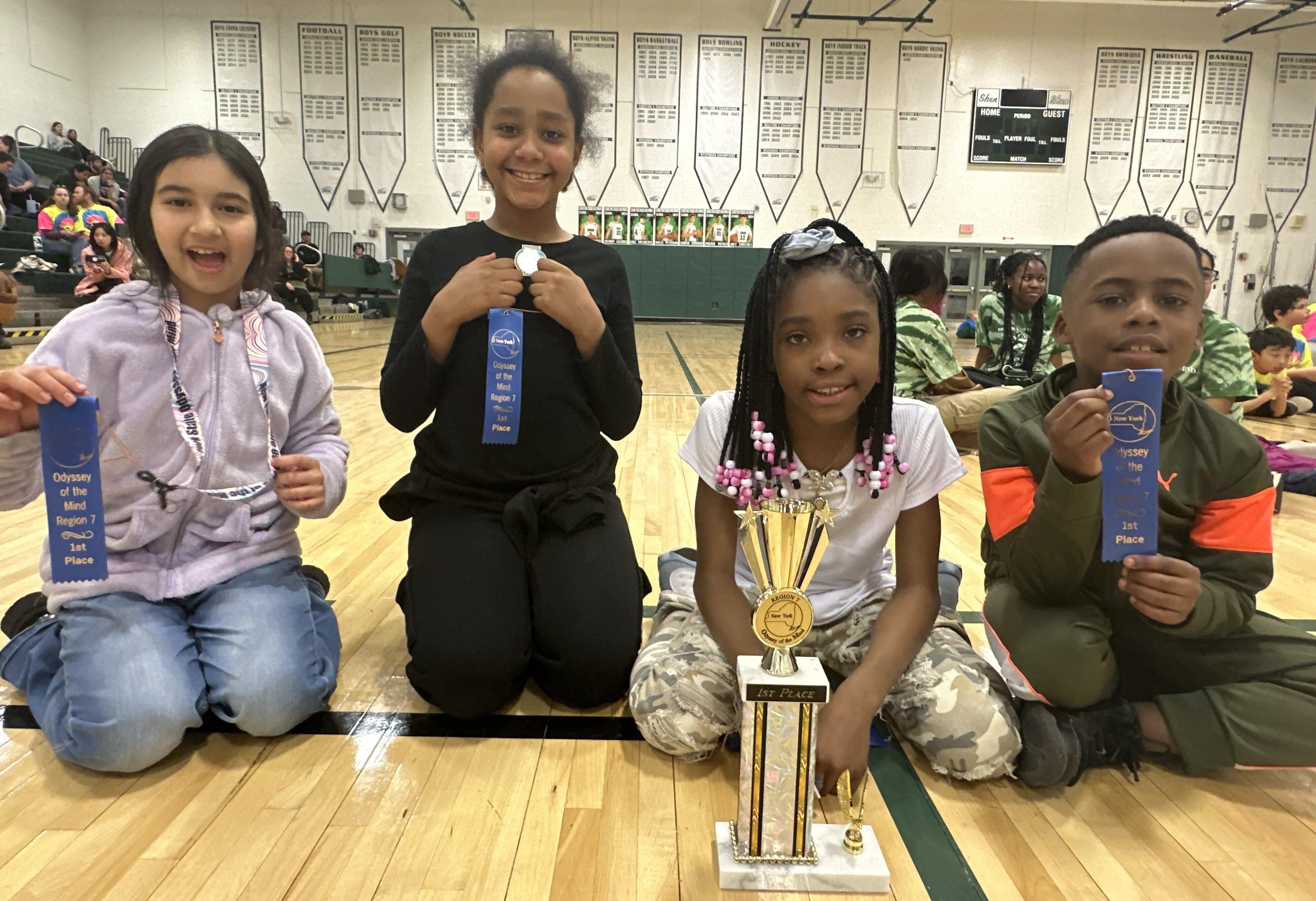 Members of the Odyssey of the Mind team posing with their award