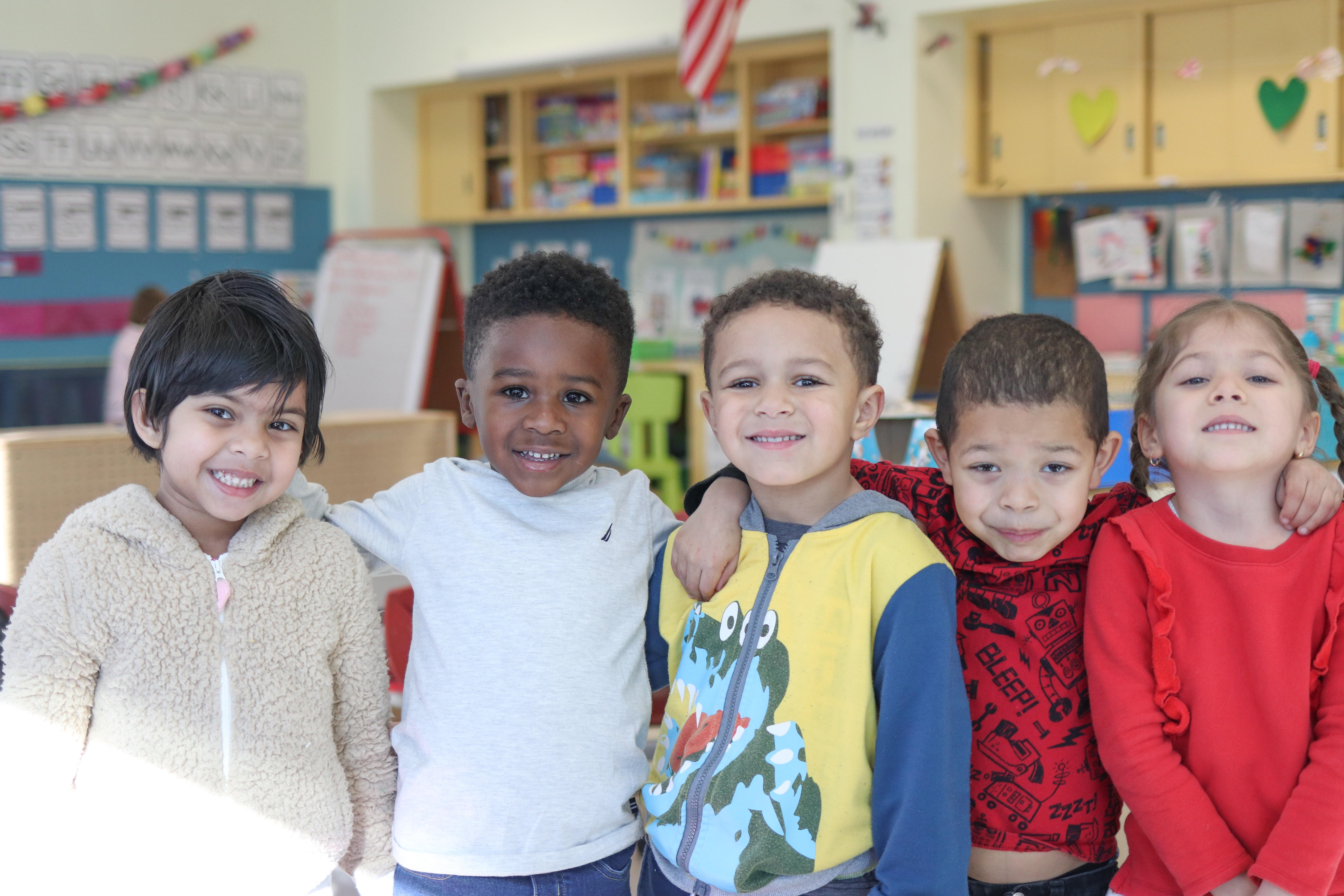 Pre-K students smiling for a picture.