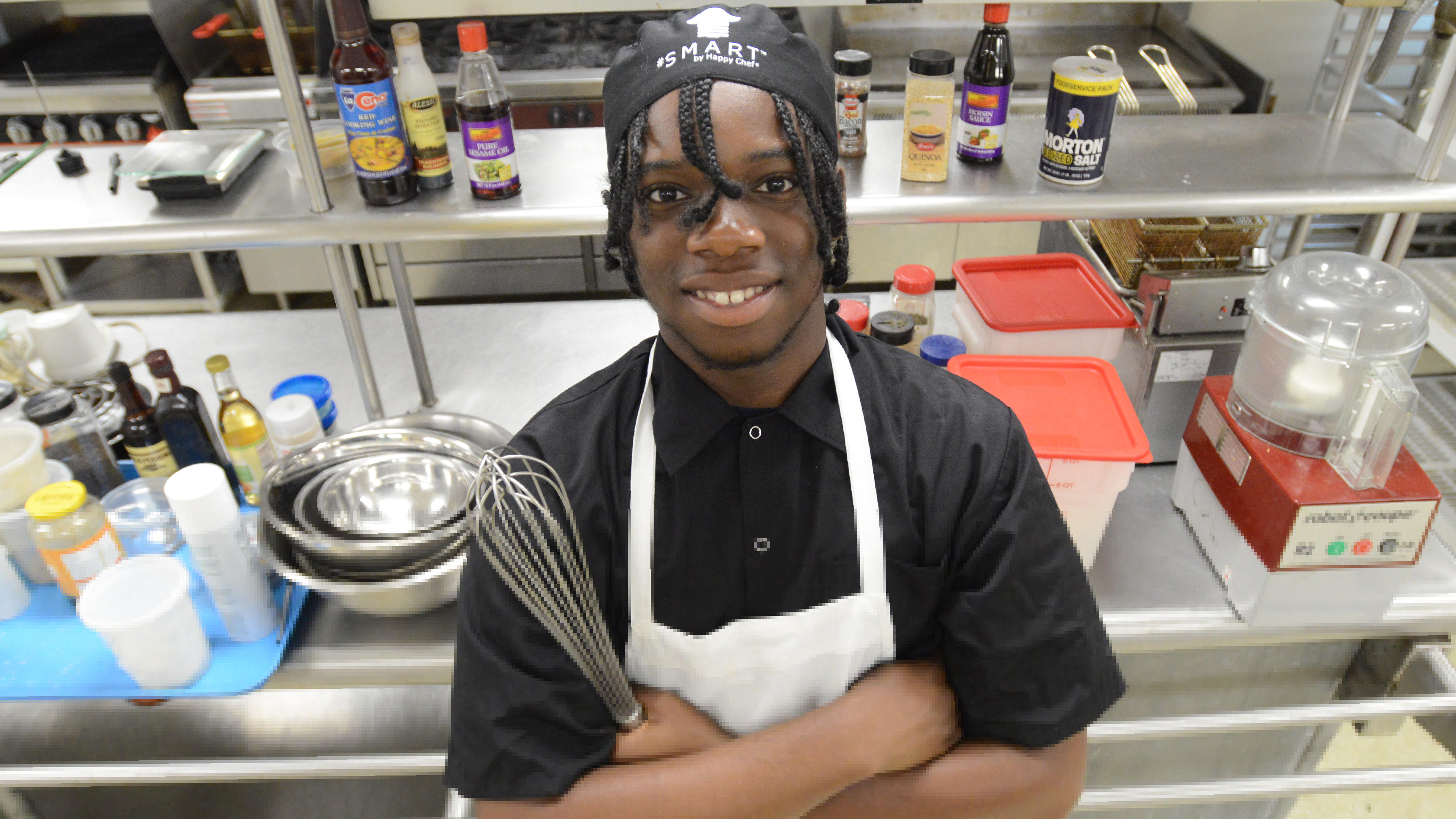 Culinary student posing in the kitchen.