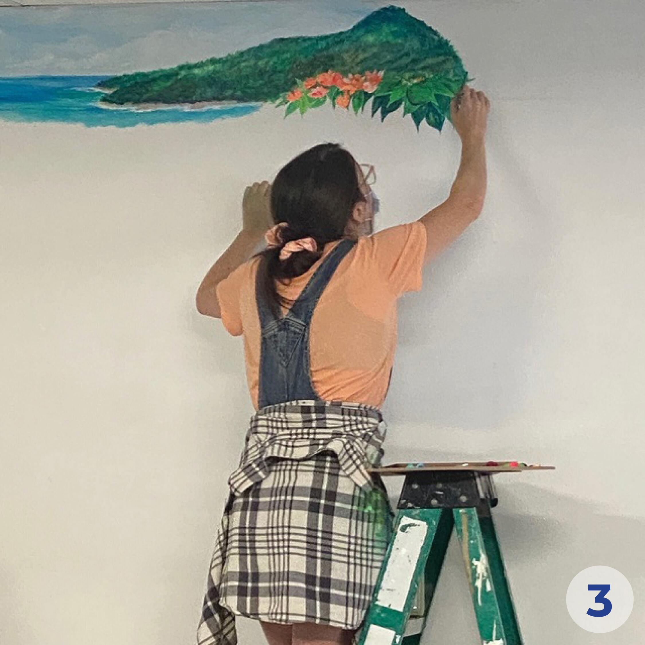 Student painting a wall